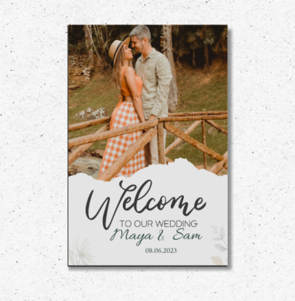 Personalized photo wedding welcome sign with couple’s picture, names, and date displayed on easel.
