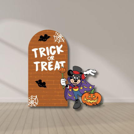 Halloween Trick or Treat orange brick arch with white lettering, spiderwebs, bats, and a costumed cartoon mouse beside a pumpkin.