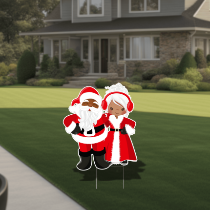 Illustrated Santa and Mrs. Claus Christmas yard sign displayed on a front lawn