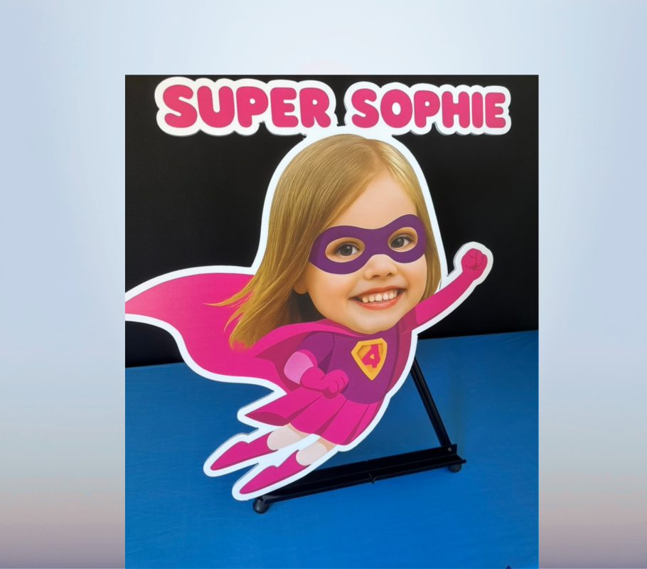 Personalized superhero character cutout featuring a child’s face, pink costume and Super Sophie name