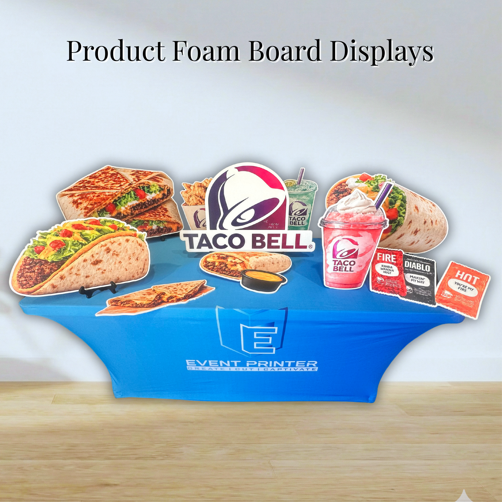 Collection of die-cut foam board food and beverage displays arranged on a promotional table