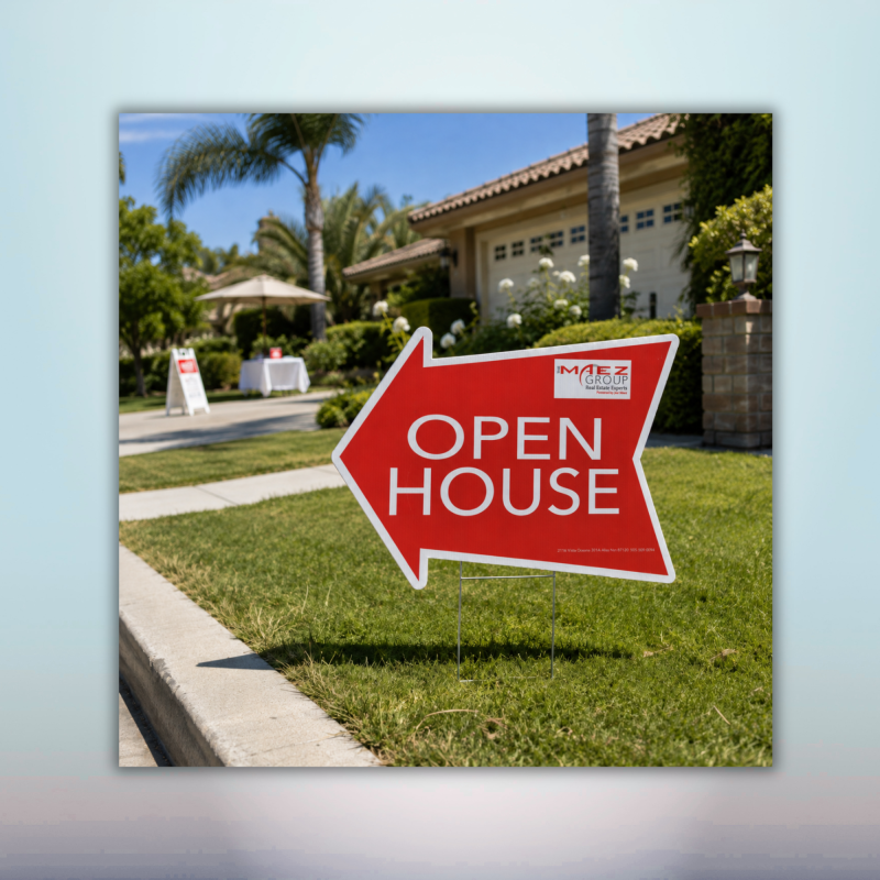 Red open house directional arrow yard sign installed outside a residential property