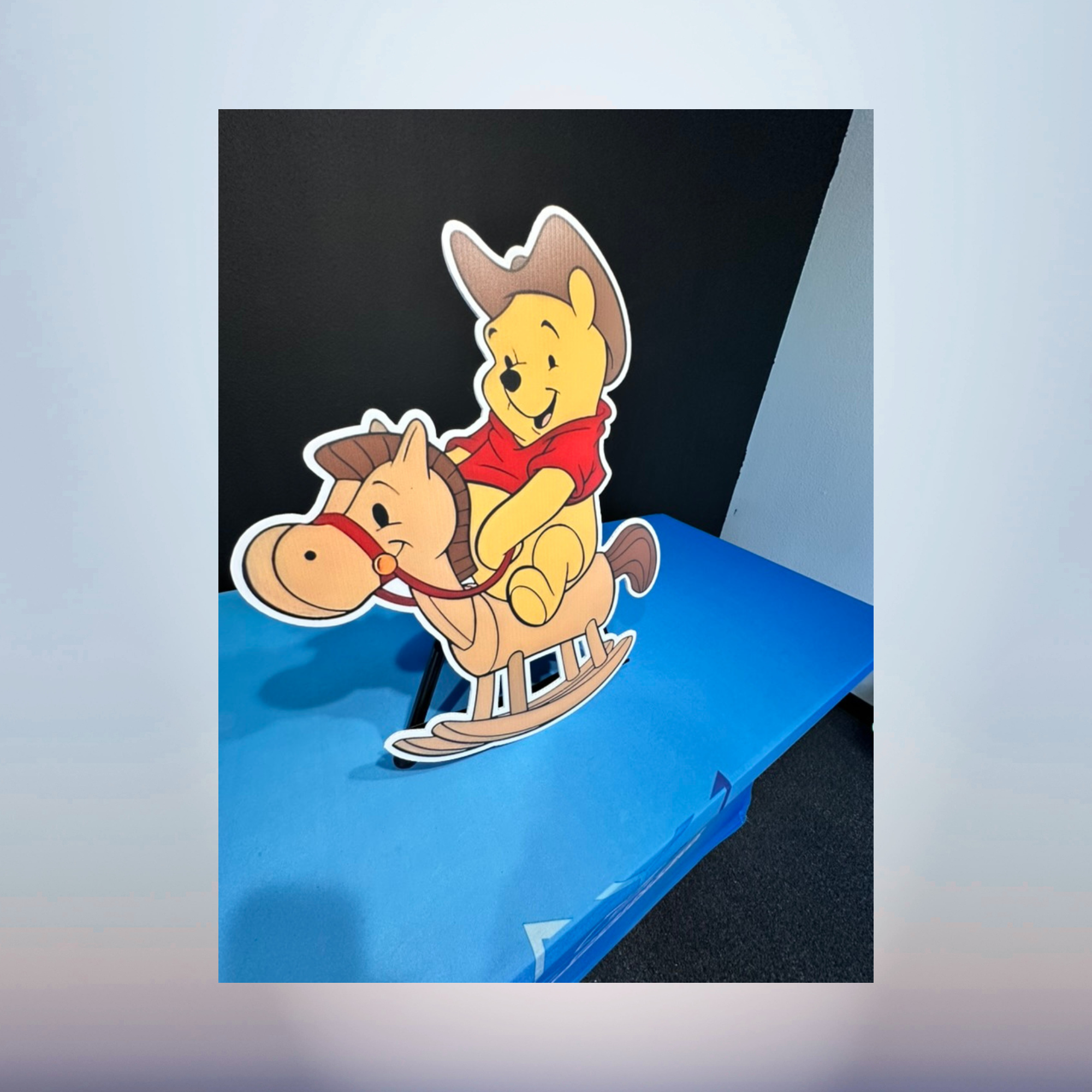 Winnie the Pooh riding a rocking horse character cutout for baby shower décor