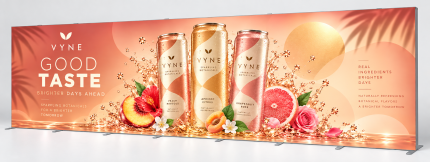 20 ft SEG fabric display with three beverage cans and custom peach-colored promotional artwork