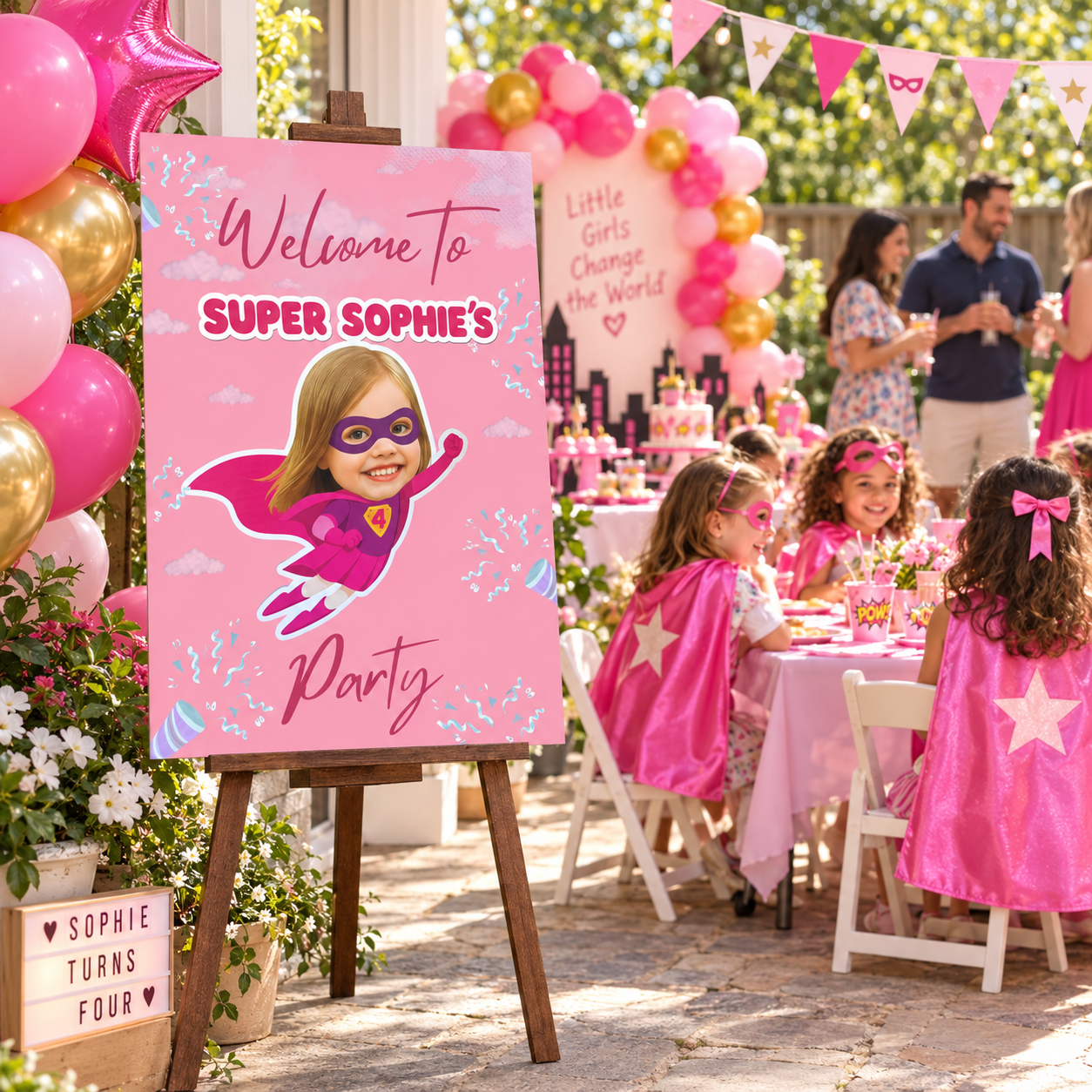 Personalized pink superhero birthday poster board on a wooden easel with a child photo and Super Sophie lettering