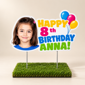 Personalized Happy 8th Birthday Anna yard sign with child's photo, bright multicolor lettering and balloons, mounted on two stakes in grass.