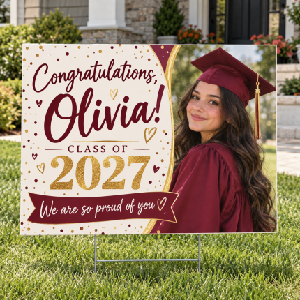 Personalized graduation yard sign featuring Olivia in a crimson cap and gown displayed on a residential lawn