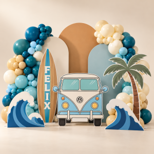 Surf birthday party display with pastel blue van cutout, surfboard, palm tree, ocean wave props, arched backdrops and blue balloon garlands.